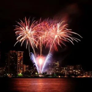 Luxury boat cruising at sunset with fireworks overhead