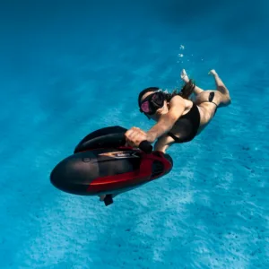 Guide fitting snorkeling gear on participant