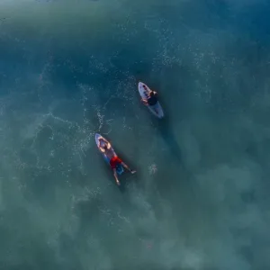 Experienced instructor guiding private surf lesson in Kauai