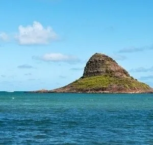 Large group exploring island coastline by bus