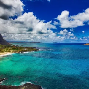 Luxury vehicle cruising along Oahu’s scenic coastline