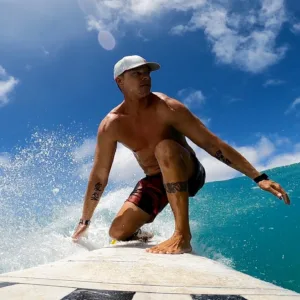 Surf instructor giving lesson to beginner with GoPro camera