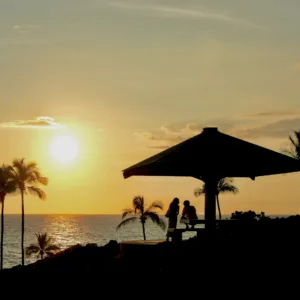 Sunset casting warm colors over tropical coastline