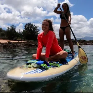 Stand up paddleboard resting on calm island waters