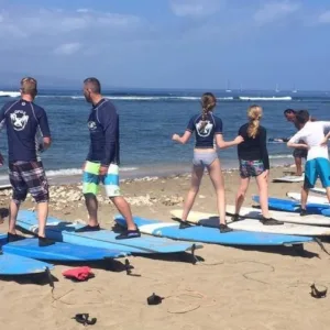 Group of beginners learning to surf together