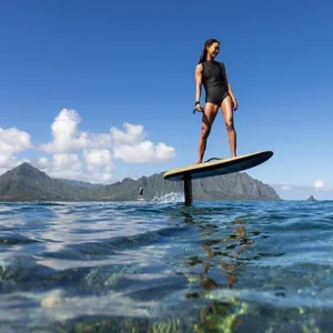 Riding an efoil board over clear tropical waters