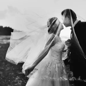 Bride and groom smiling during elegant outdoor wedding ceremony