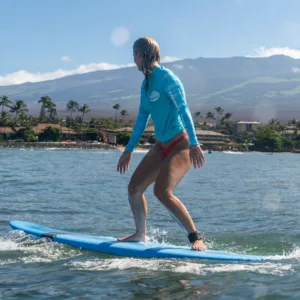 Instructor teaching private surf lesson on sunny beach
