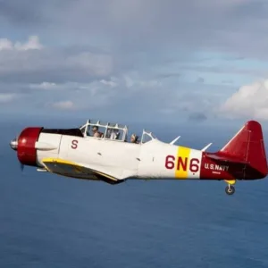 Warbird aircraft flying low over Pearl Harbor waters
