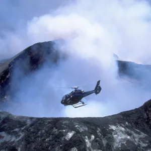 Helicopter flying over volcanic landscape near Hilo