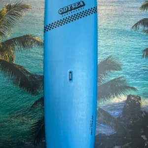 Blue 10 foot Odysea surfboard on shore at sunrise