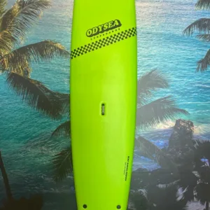 Green 9 foot Odysea surfboard on sandy beach