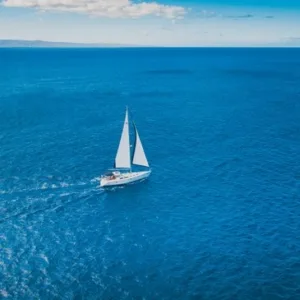 Snorkelers exploring coral reefs from Monohull Nova sailboat