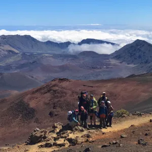 Hikers trekking on Haleakala volcanic landscape trail