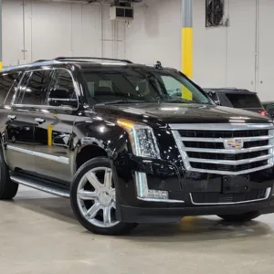 Private Cadillac sedan waiting outside hotel for airport transfer