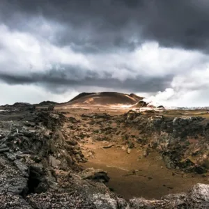 Hikers trekking along volcanic landscape in Hawaii