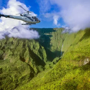 Family enjoying doors-on helicopter tour over Kauai island