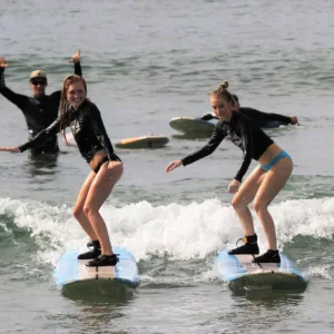 Group of surfers catching waves together in Maui