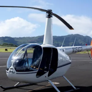 Private helicopter flying over Kauai's lush landscape