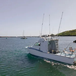 Shared fishing charter boat cruising open ocean waters