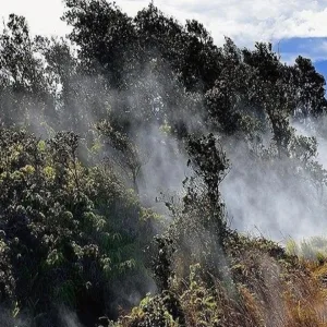 Helicopter flying over Hawaii volcano landscape