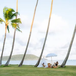 Couple enjoying luxury picnic setup on sandy beach