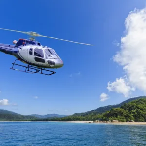 Helicopter flying over active Hawaiian volcano landscape