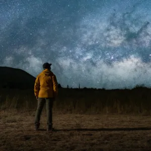 Stargazers observing Mauna Kea night sky with telescope