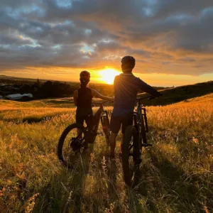 Cyclists riding along a scenic ranch trail