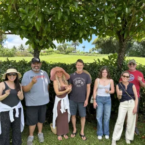 Tour guide leading visitors through pineapple fields