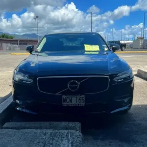 Black luxury sedan waiting at Honolulu airport arrival area