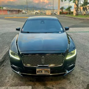 Luxury sedan parked at Waikiki hotel arrival area