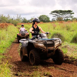 ATV riding through lush ranch landscape