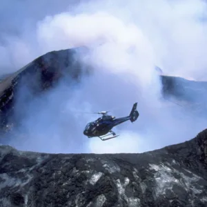 Helicopter flying over active volcanic landscape