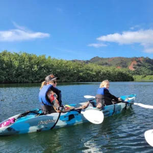 Two people paddling double kayak on river