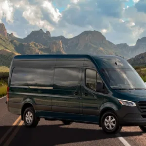 Shuttle bus parked outside Waikiki hotel for airport transfer