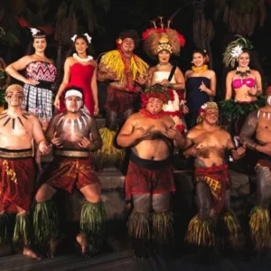 Luau guests tasting traditional Hawaiian foods