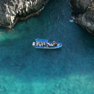 Snorkelers exploring sea caves along rocky coastline