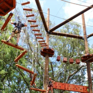 Participant climbing obstacle on island ninja adventure course