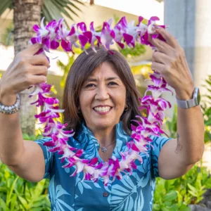 Fresh single-strand orchid lei on display