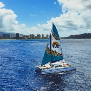 Sailboat gliding along Waikiki shore with Diamond Head view