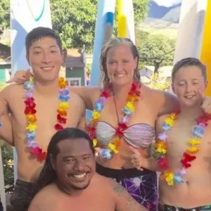 Group learning stand up paddleboarding on ocean waves
