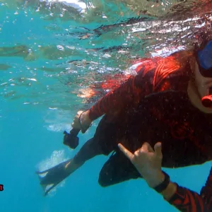 Ocean kayak near coral reef with snorkelers nearby