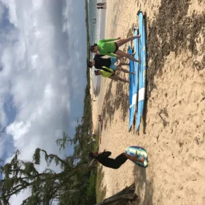 Surf instructor coaching private group on beach