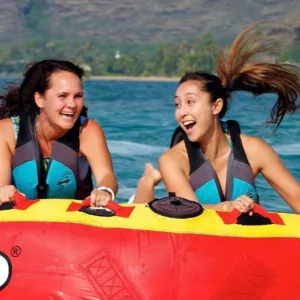 Excited rider sliding down a water bumper tube ride