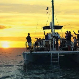 Small group enjoying Waikiki sunset cruise with drinks