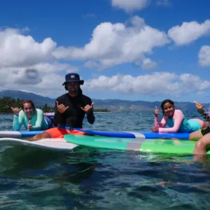 Group of surfers enjoying a private lesson together