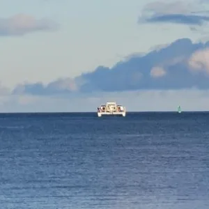Power catamaran cruising at sunset on Big Island