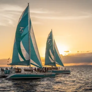Elegant dinner sailboat cruising near Na Pali Coast at dusk