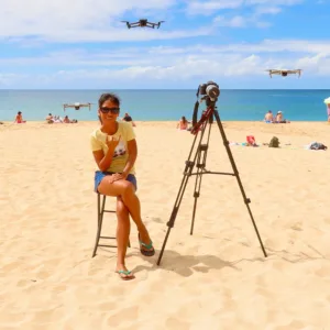 Drone flying over Oahu surf spot capturing wave riders